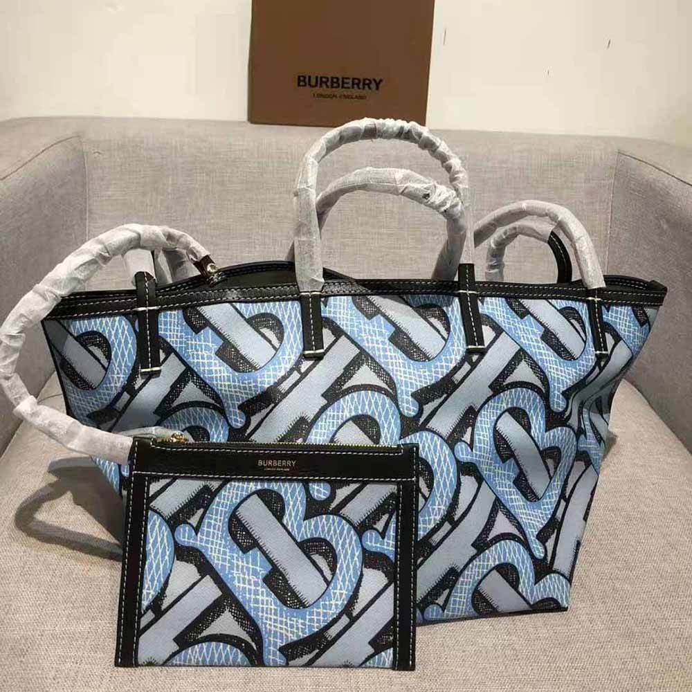 Side angle showing blue e-canvas and monogram detail on Burberry tote
