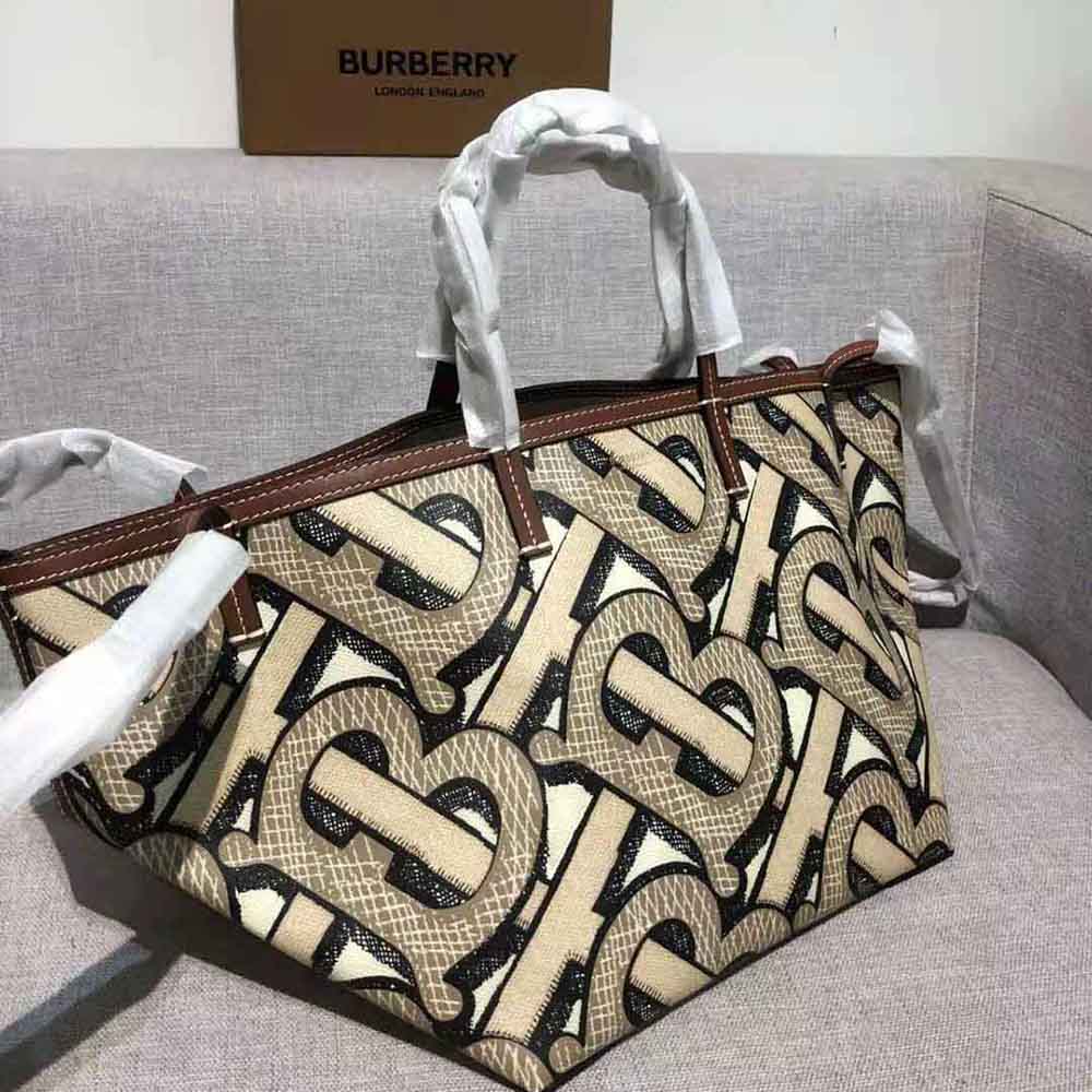 Side angle showing zip closure and tote silhouette in brown