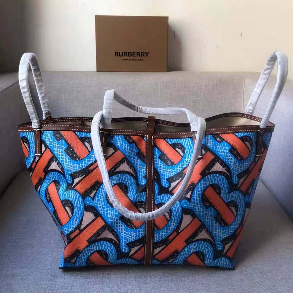 Side angle showing compact shape of Burberry Mini Monogram Print Tote
