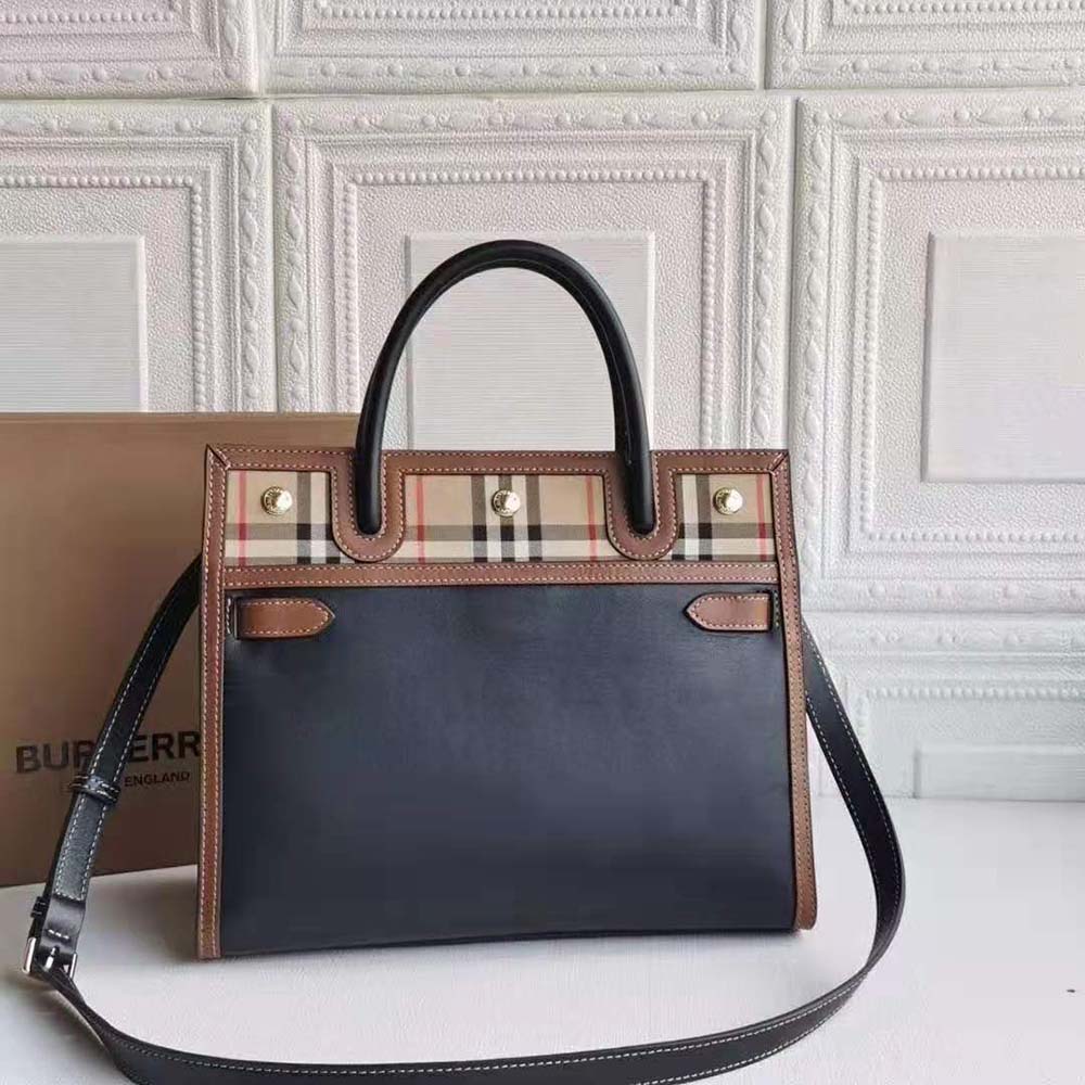 Close-up of vintage check fabric and black leather handles detail