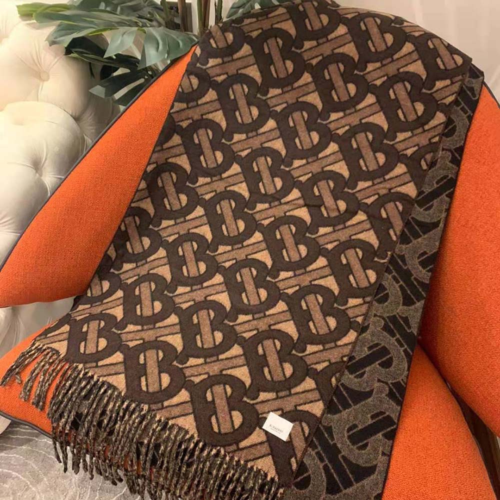 Close-up detail of brown cashmere monogram weave on Burberry scarf