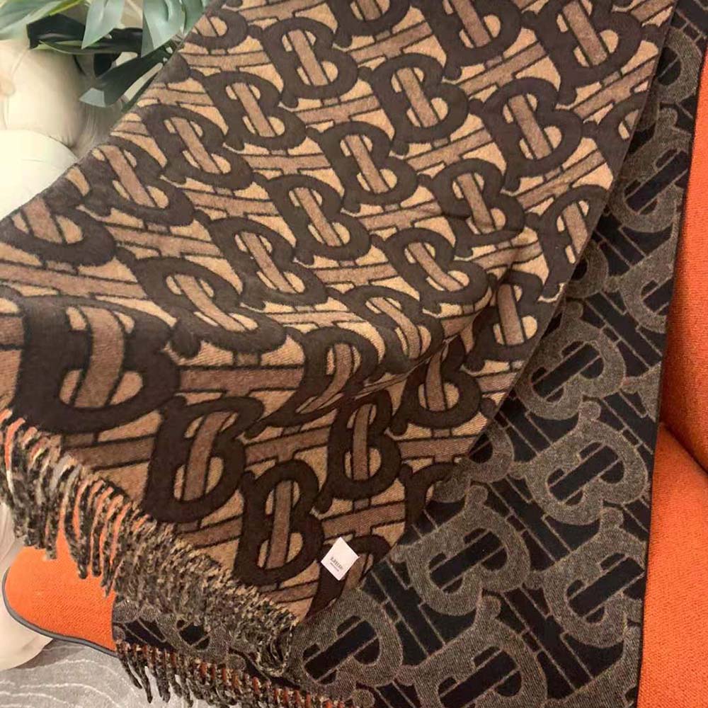 Side angle showing length and texture of Burberry Women Monogram Cashmere Jacquard Scarf-Brown