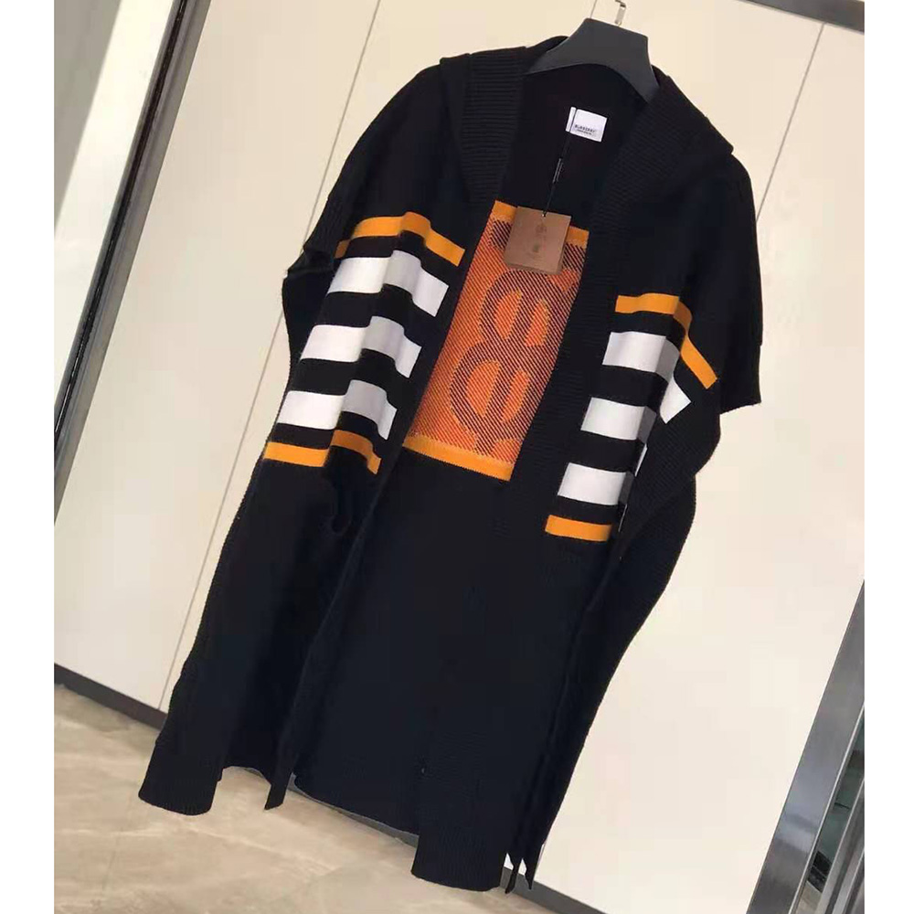 Close-up of Burberry monogram intarsia detail on black wool cashmere cape
