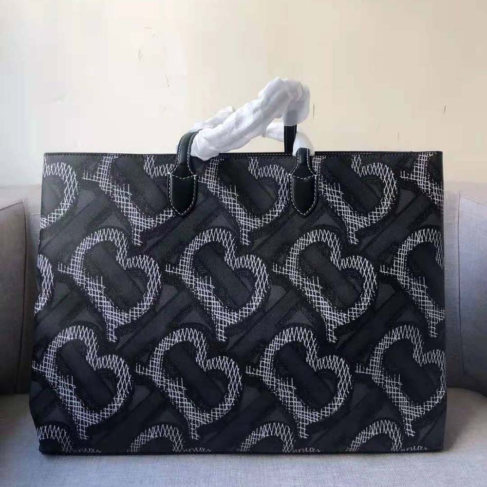Side angle showing tote bag handles and sleek silhouette