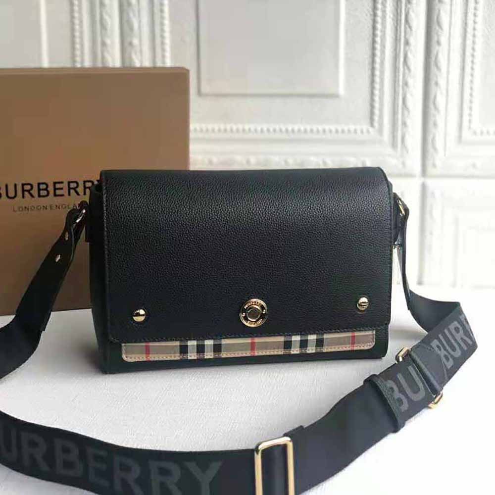 Close-up of black leather and Vintage Check canvas details on Burberry bag
