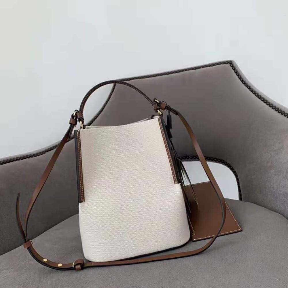 Side angle showing bucket silhouette and magnetic closure of Burberry Peggy Bucket Bag