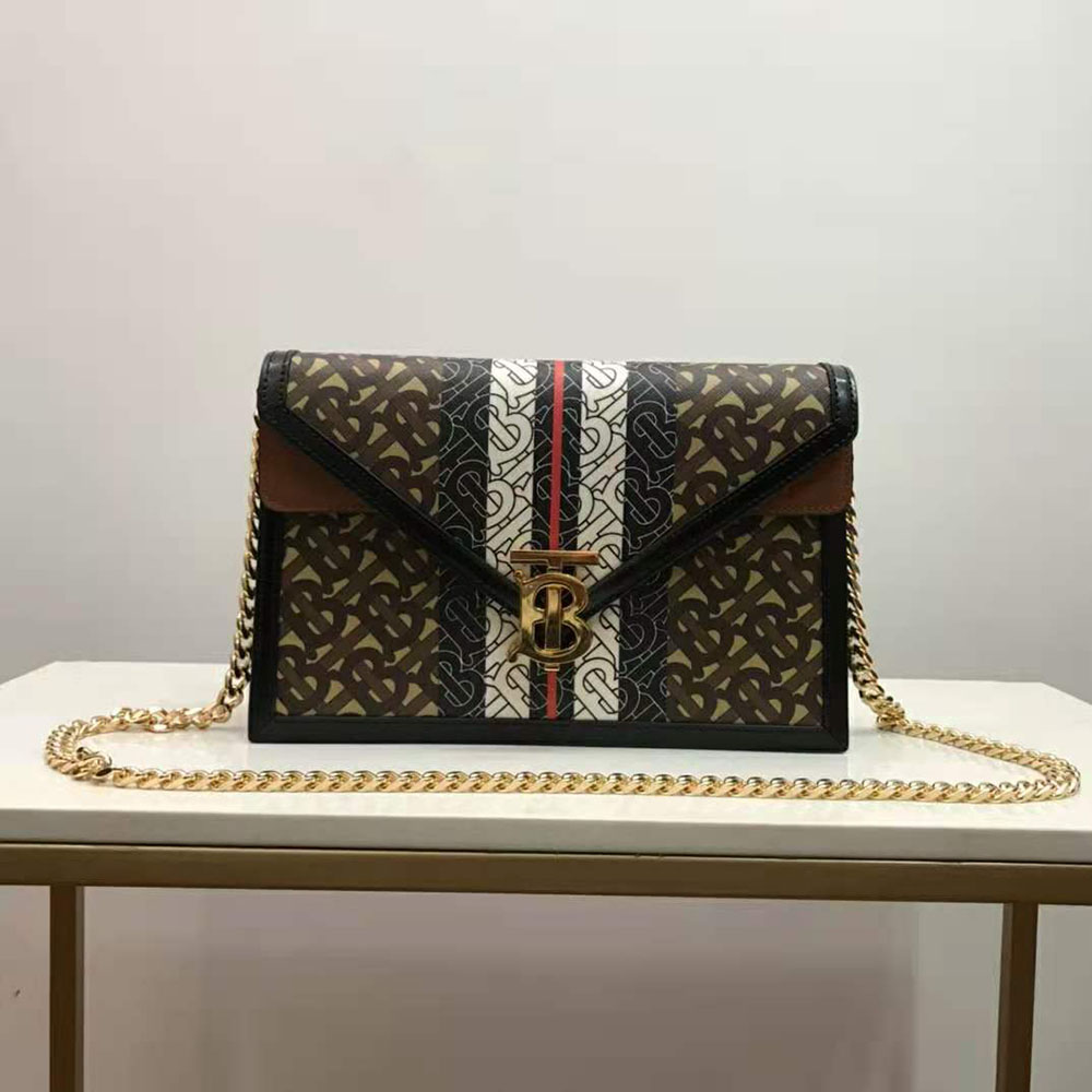 Close-up of TB monogram stripe hardware on Burberry clutch