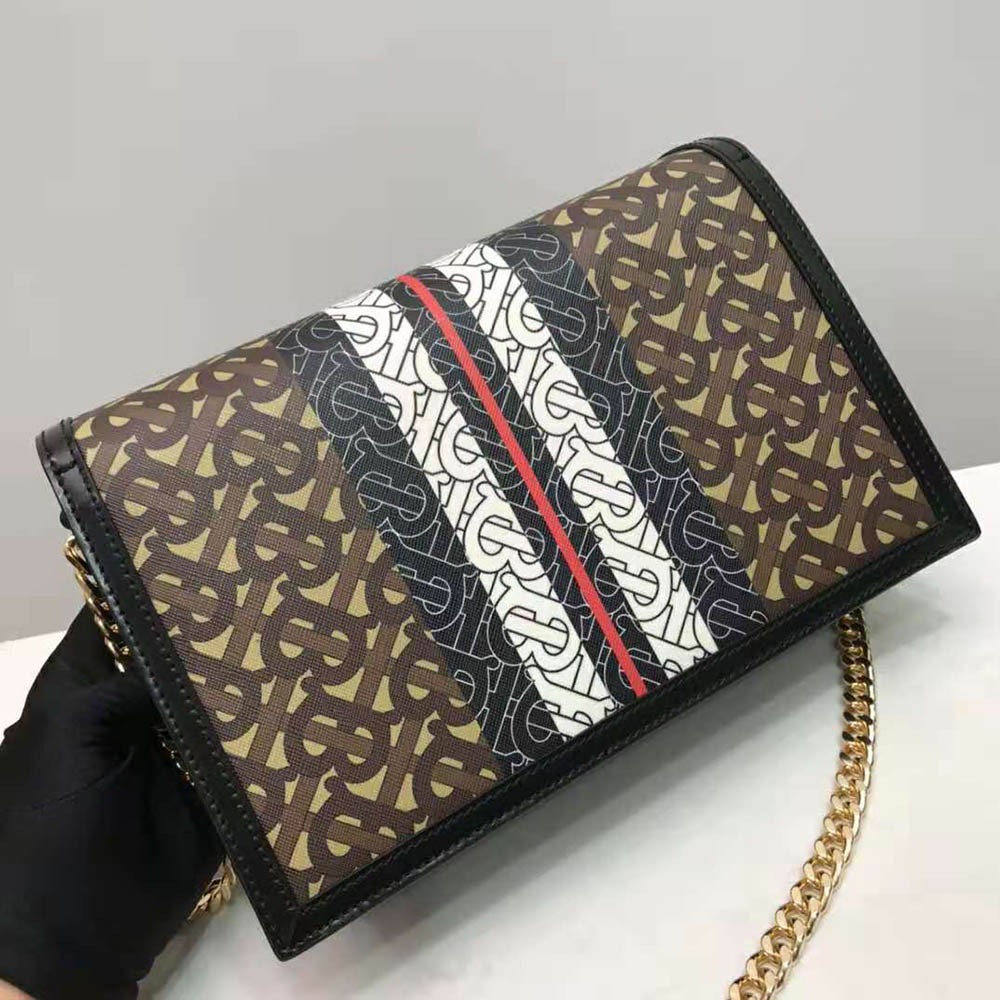 Side profile highlighting brown leather trim on Burberry envelope clutch