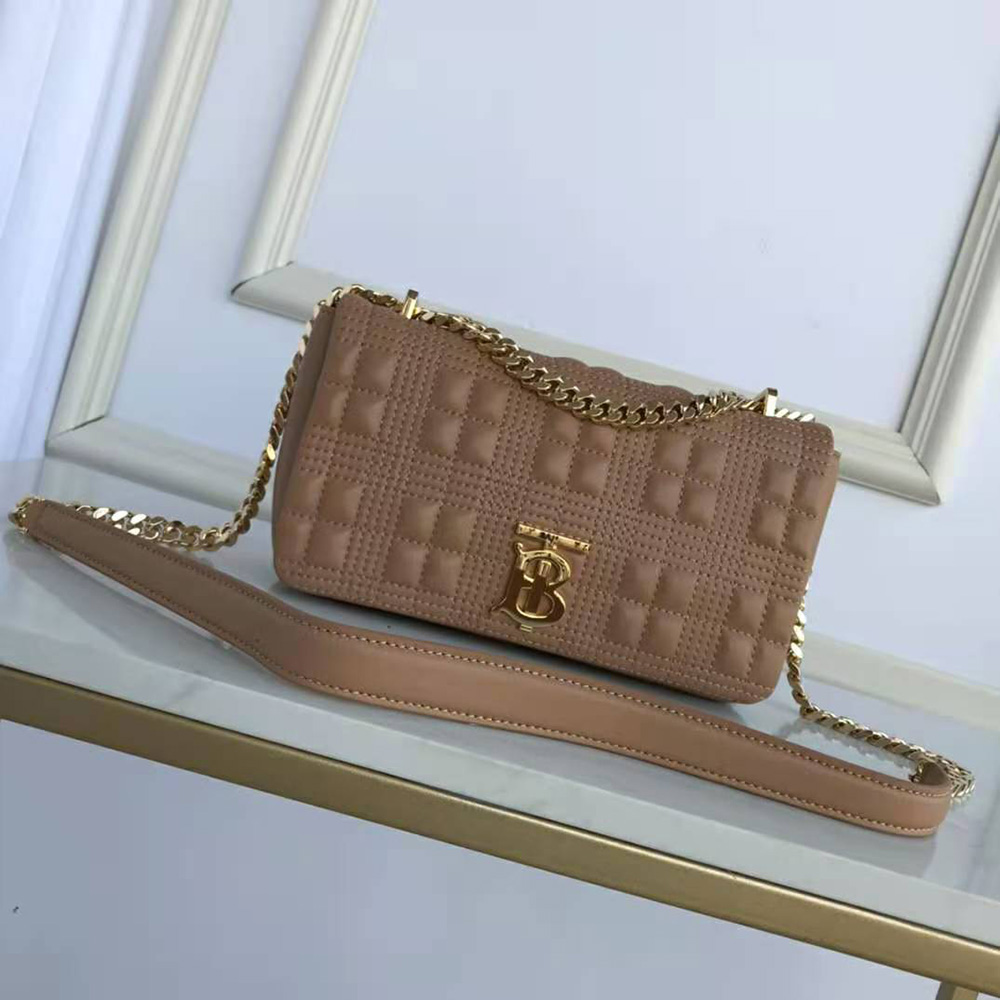 Close-up of quilted lambskin texture and gold hardware on Burberry bag