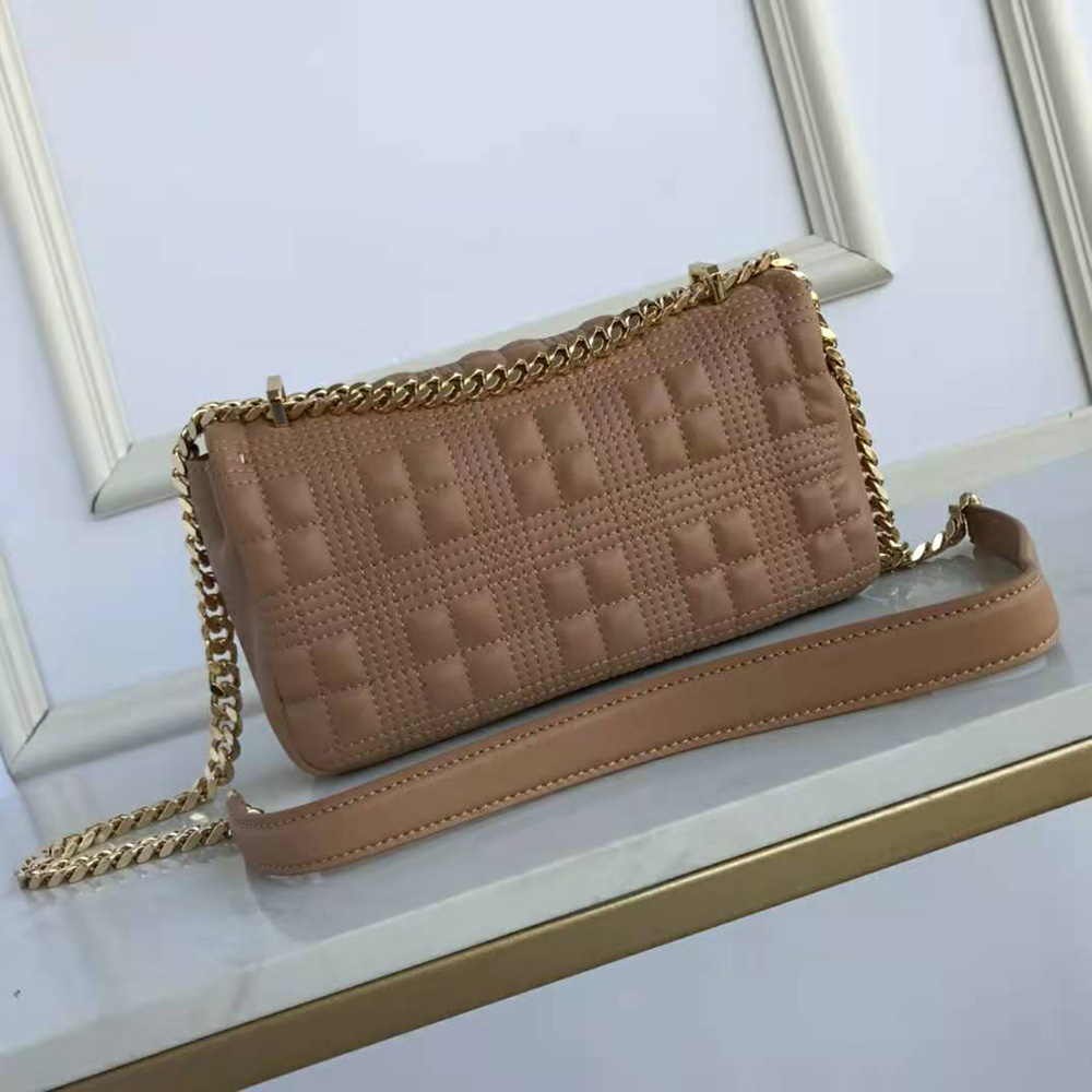 Side angle showing the sandy leather and strap of Burberry Lola Bag