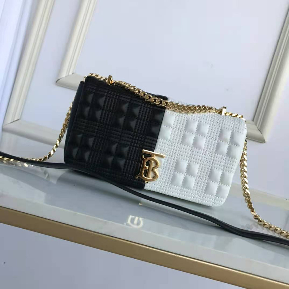 Close-up of gold-tone signature hardware on Burberry Lola Bag black leather