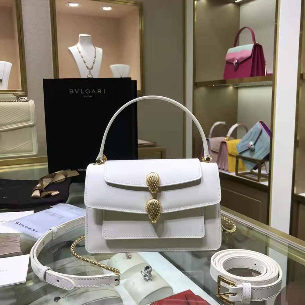 Close-up of silver Bvlgari hardware on white leather belt bag