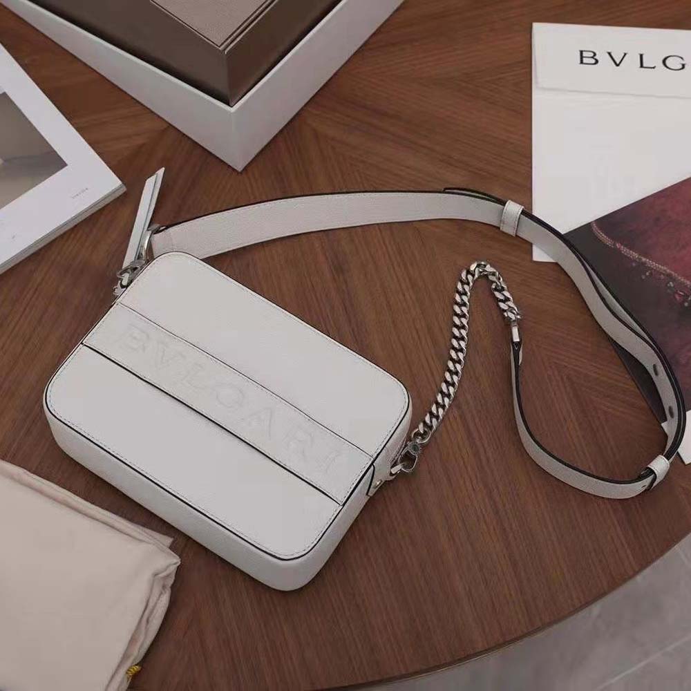 Close-up of gold Bvlgari logo hardware on white leather bag