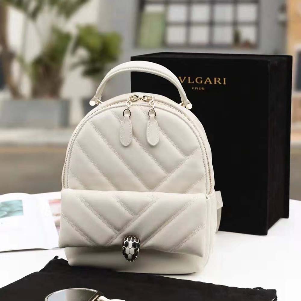 Close-up of Serpenti cabochon closure on Bvlgari White Agate Calf Leather backpack