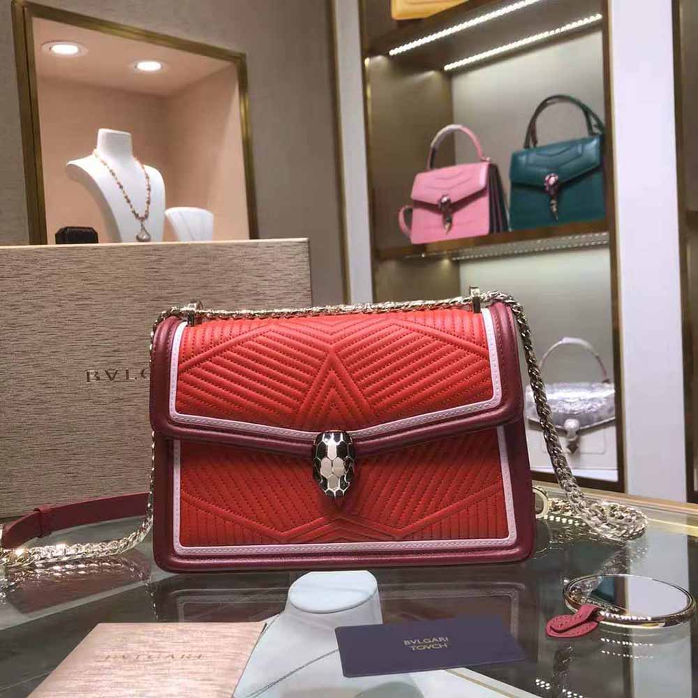 Close-up of red leather and gold hardware on Bvlgari Serpenti Forever bag