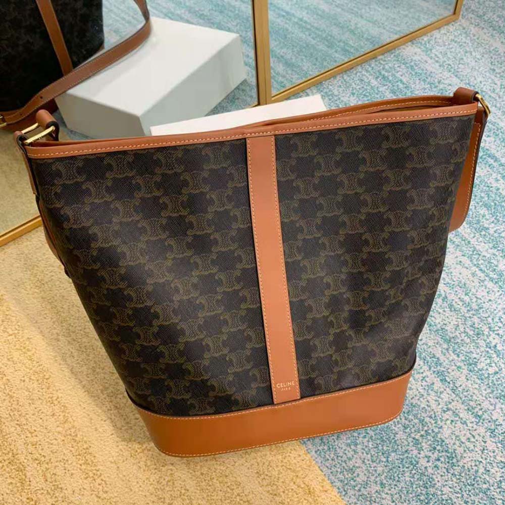 Side profile showing shape of Celine Women Medium Bucket in Triomphe Canvas-Brown