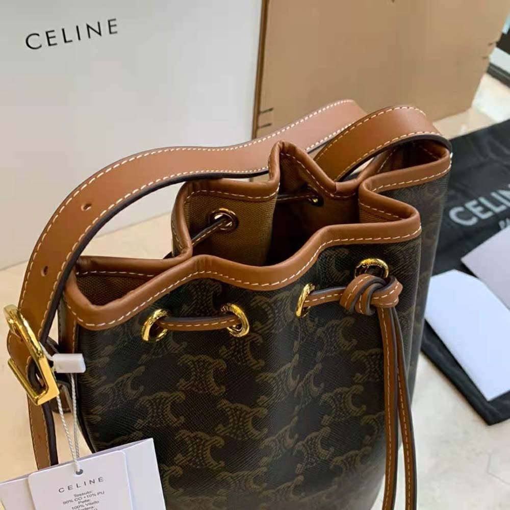 Side profile showing leather trim detail on Celine Women Small Drawstring Bag in Triomphe Canvas