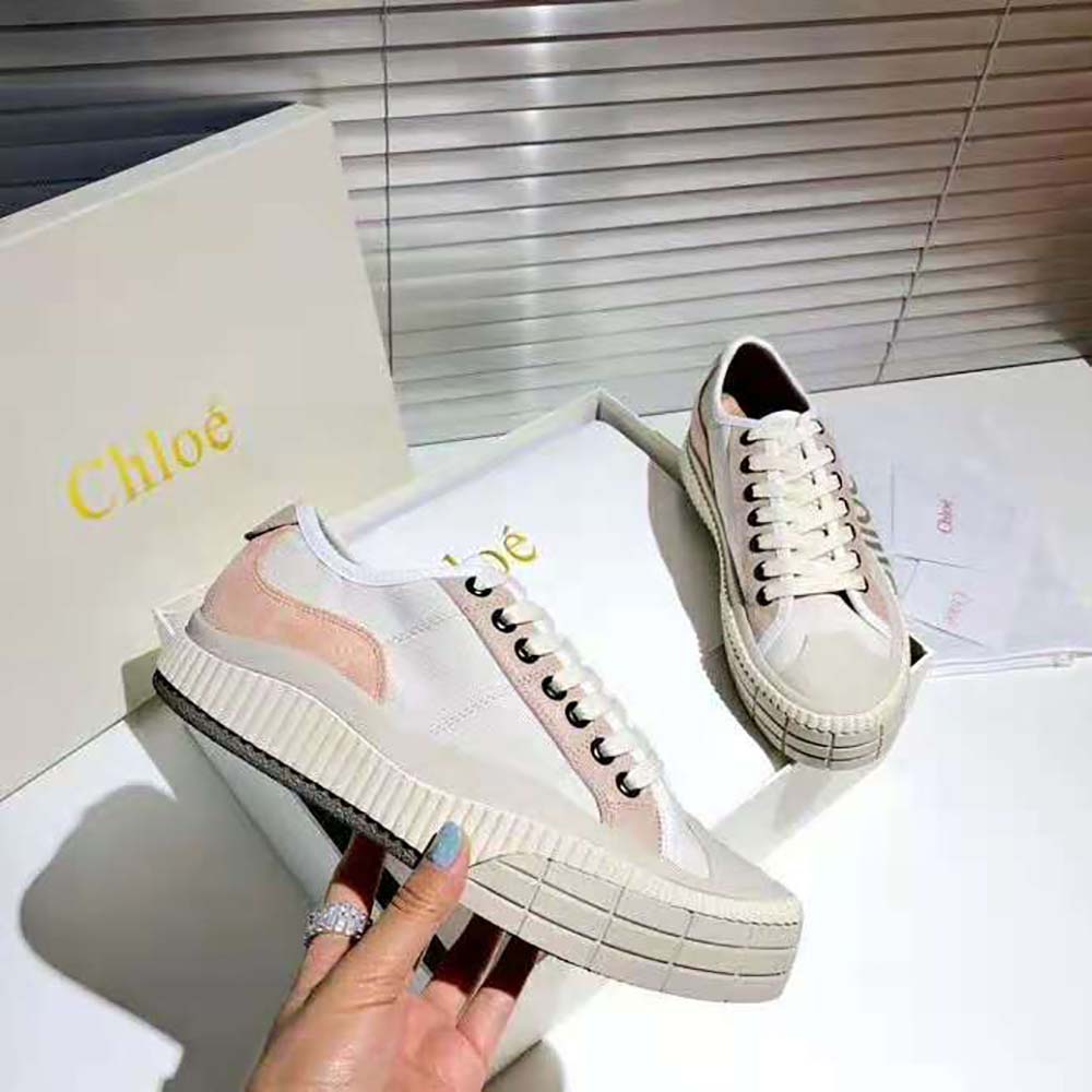 Close-up of pink suede calfskin and embossed Chloé logo hardware