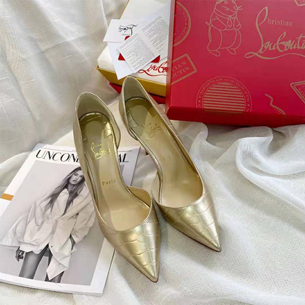 Close-up on gold patent leather and signature red sole of Lriza heel