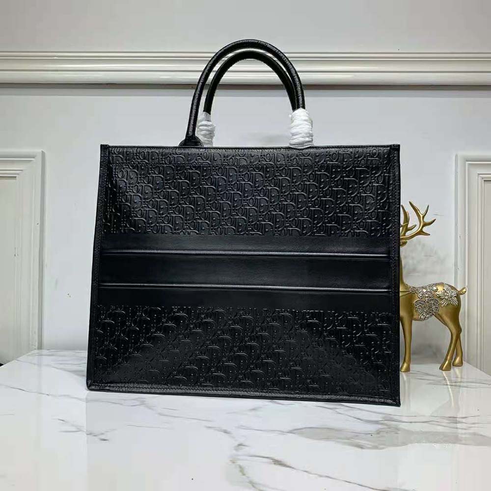 Side angle showing spacious interior and top zipper of Dior Book Tote Black