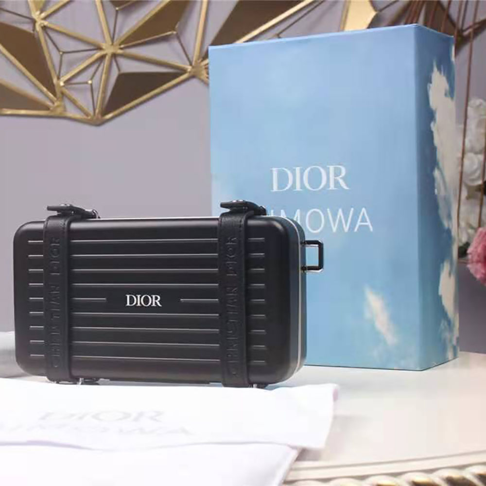 Side profile showing slim silhouette of Dior Men Dior and Rimowa clutch
