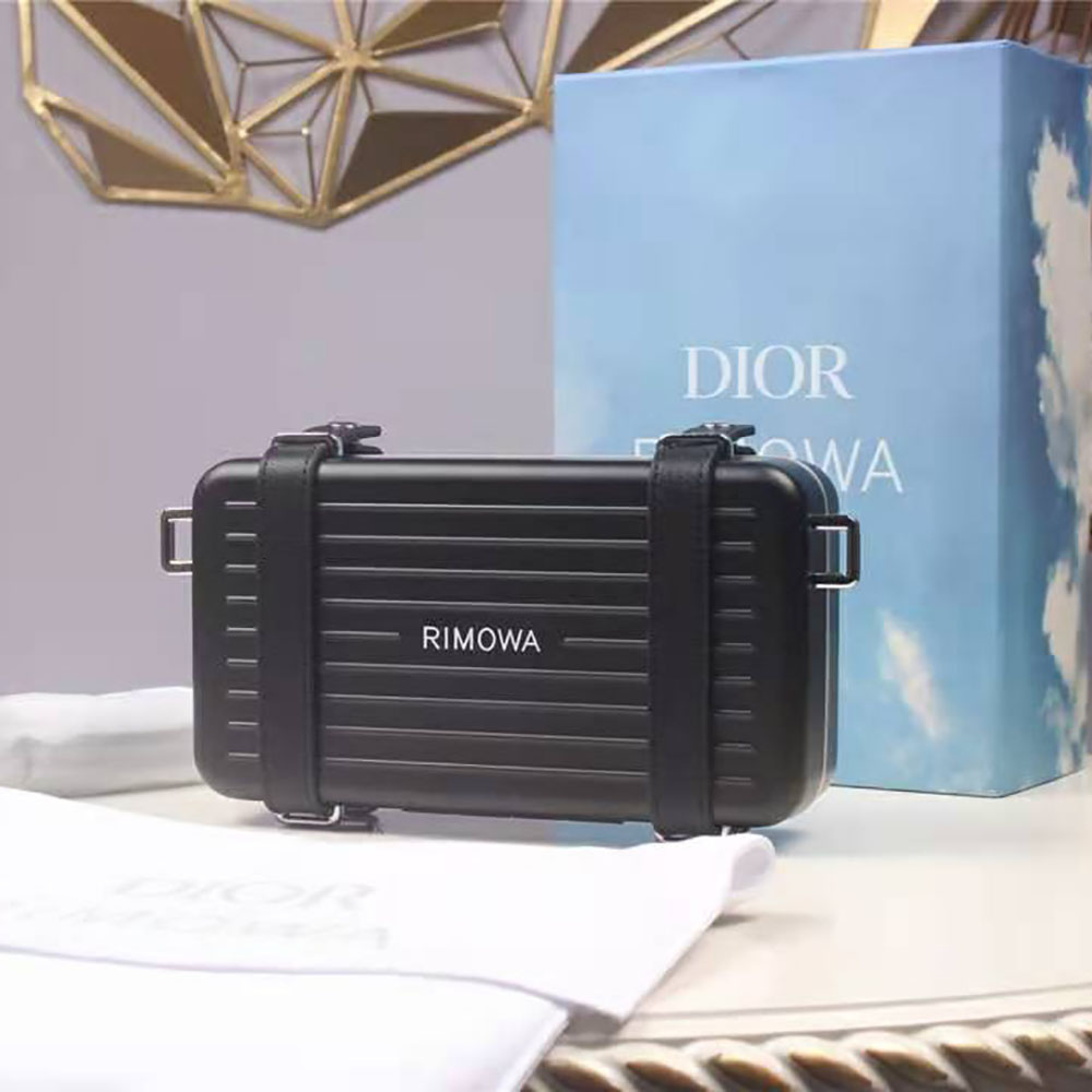 Close-up of aluminum frame and signature hardware on Dior Men clutch