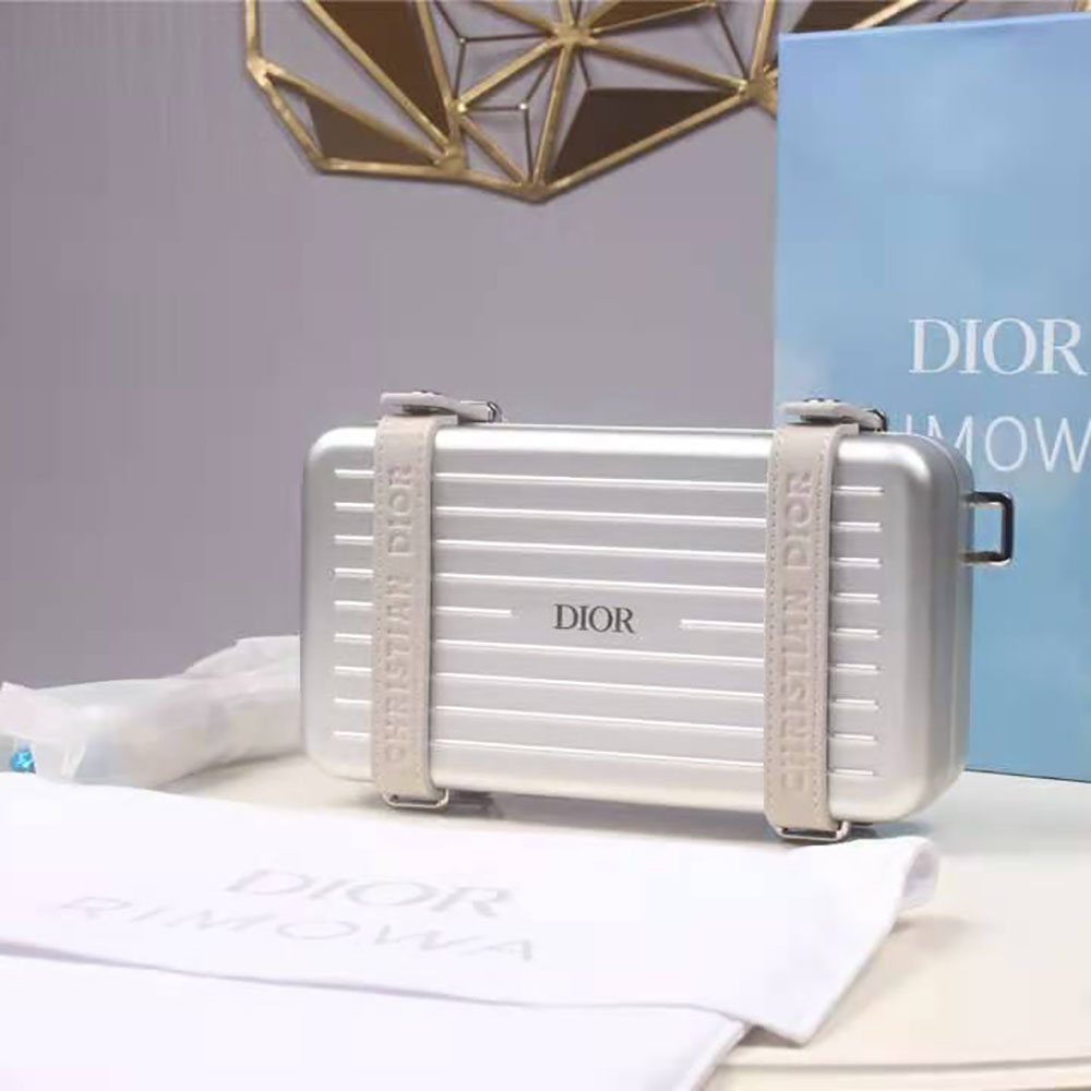 Close-up of zipper and embossed hardware on Dior Men Dior and Rimowa clutch