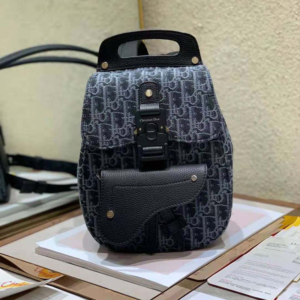 Close-up of silver-tone hardware on Dior Men Mini Saddle Backpack