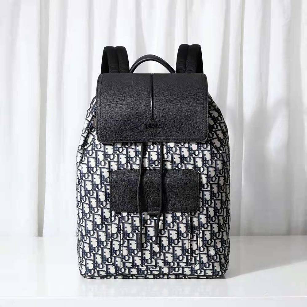 Close-up of black grained calfskin and silver hardware details on Dior Men Motion Backpack