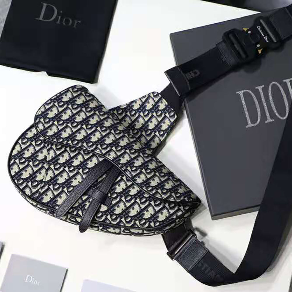 Close-up of silver-tone ‘CD’ hardware on Dior Men Saddle Bag