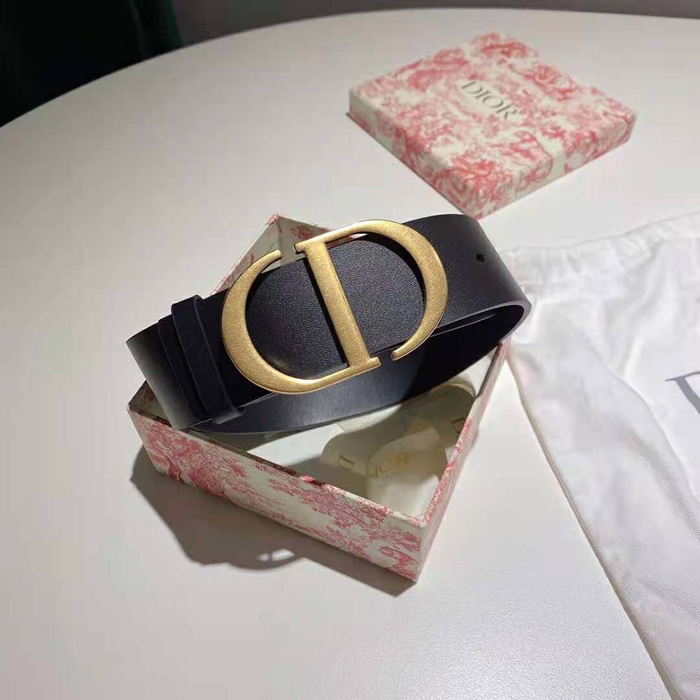 Close-up of black leather texture and Dior engraved buckle detail
