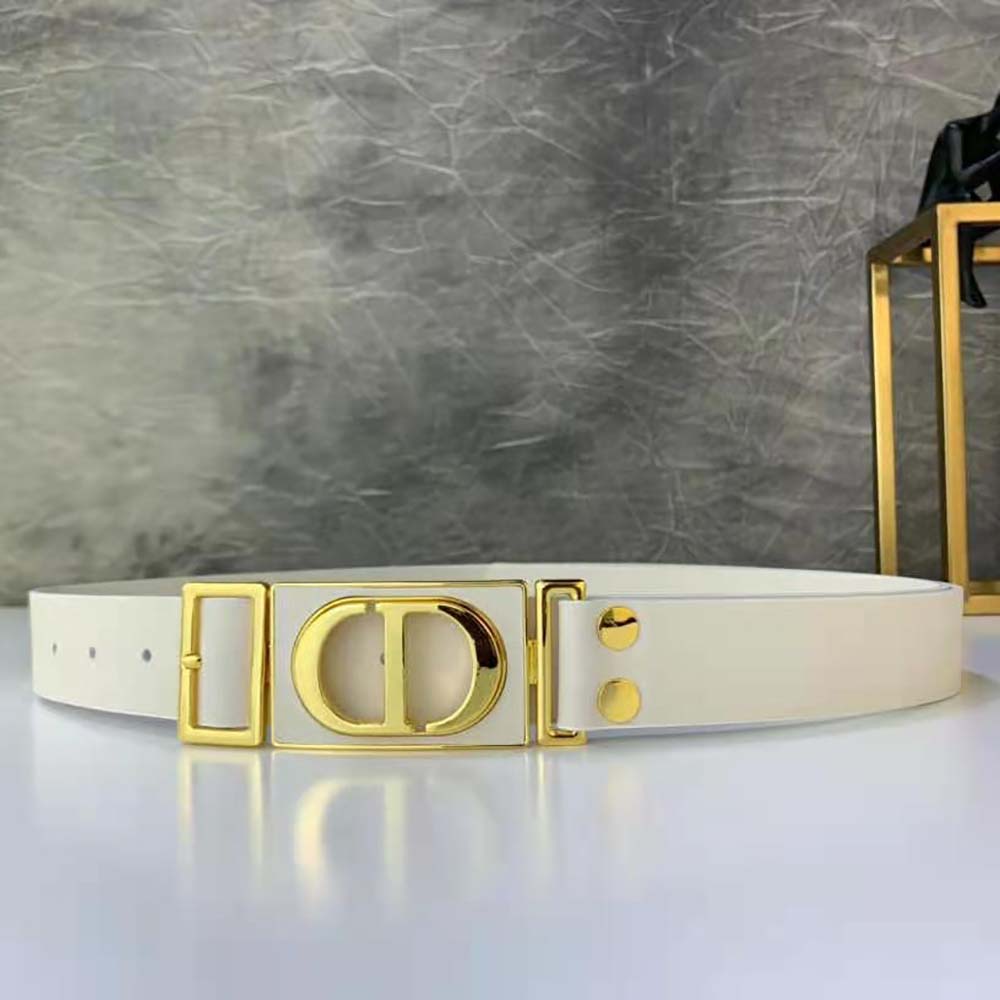 Close-up of Dior logo hardware on white calfskin belt