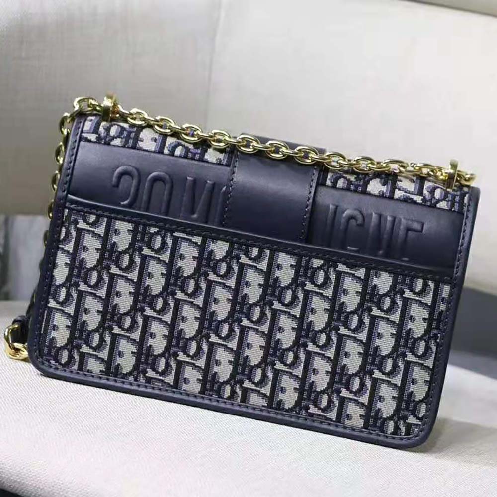 Side angle showing chain strap and jacquard texture of Dior bag