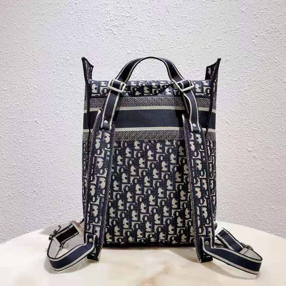 Side angle of Dior Women Backpack Blue Dior Oblique Embroidery highlighting silhouette and straps