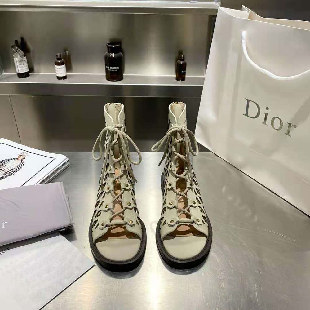 Close-up on Dior signature buckle of Beige D-Trap Sandal