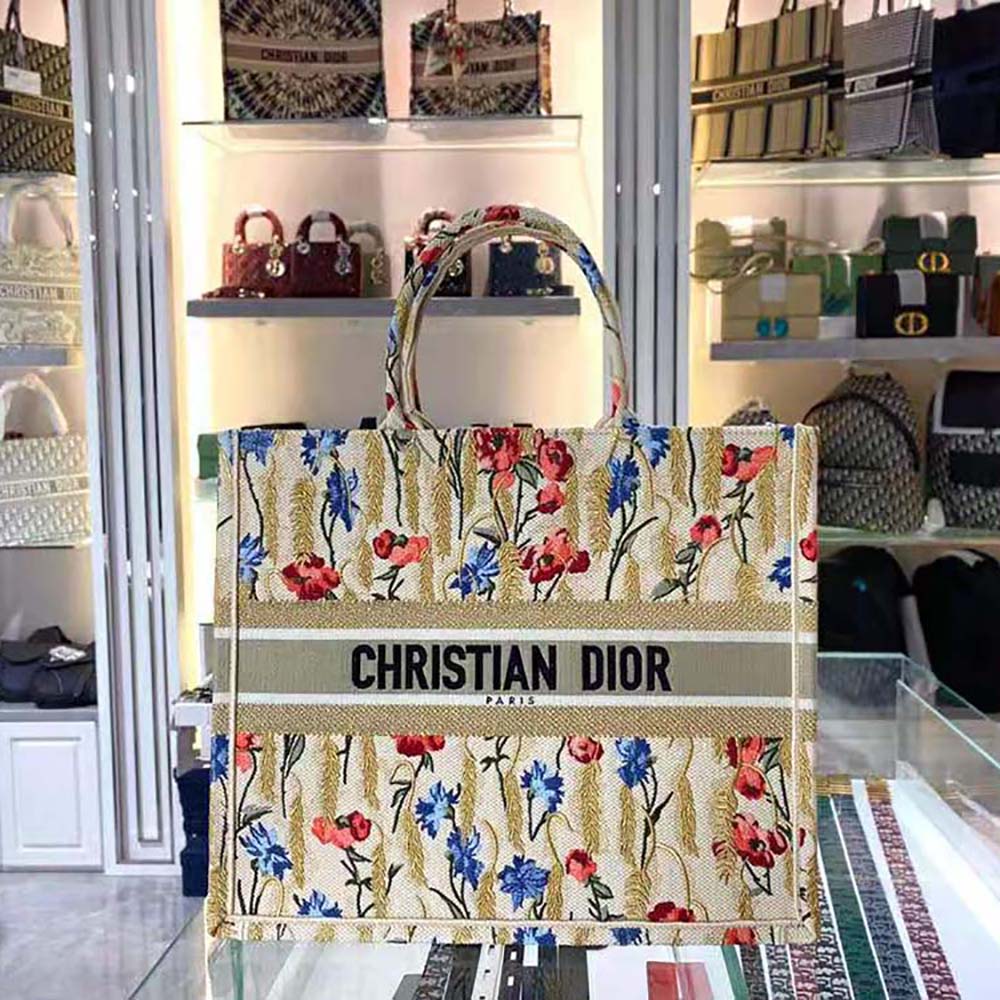 Close-up of hibiscus embroidery detail on Dior Book Tote beige canvas