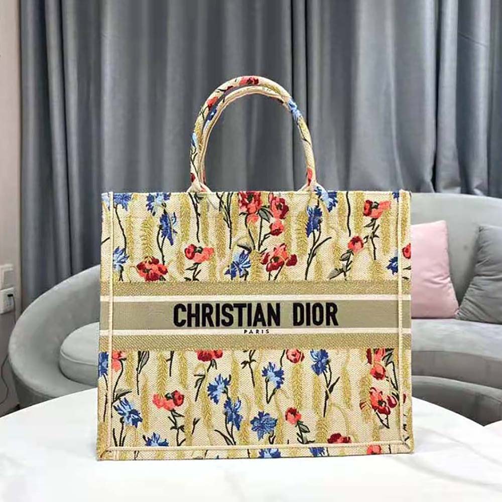 Side angle showing silver hardware and handles of Dior Book Tote