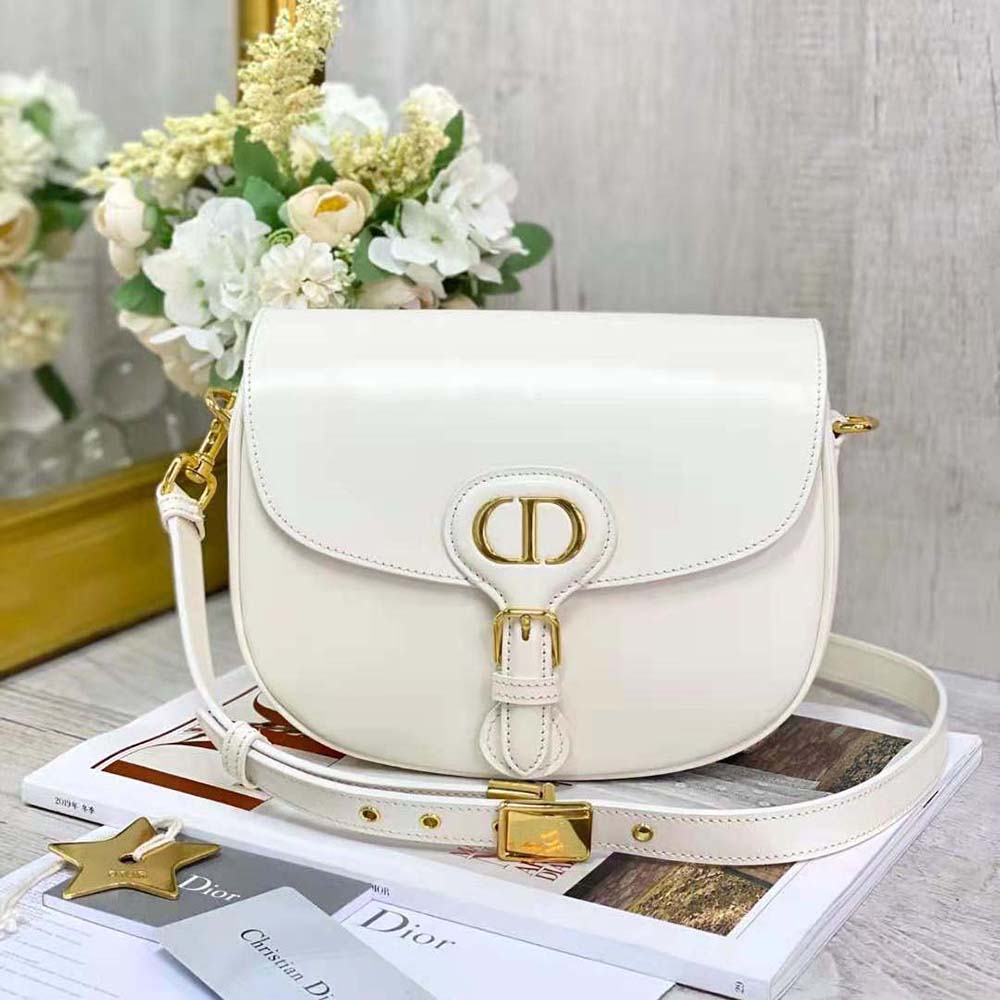 Close-up on matte silver 'CD' hardware of Dior Women Medium Dior Bobby Bag Latte Box Calfskin