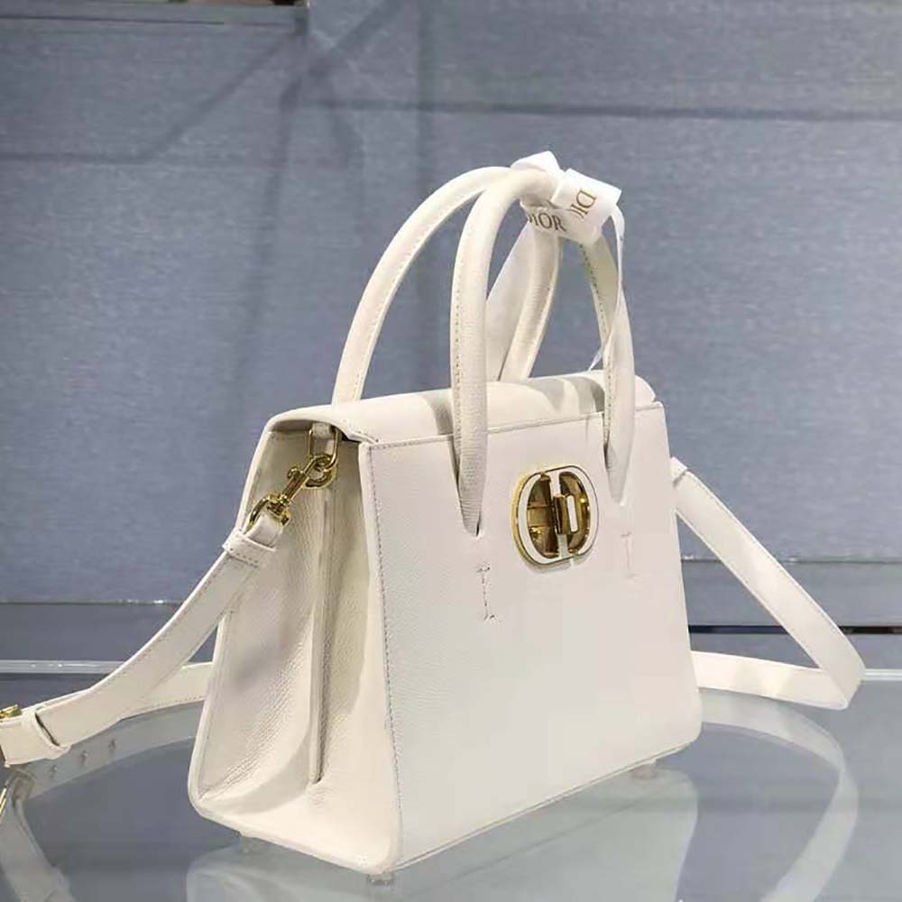 Close-up of silver Dior hardware on white grained calfskin tote