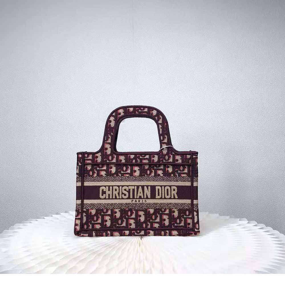 Close-up detail of Dior Oblique embroidery on Mini Dior Book Tote maroon canvas