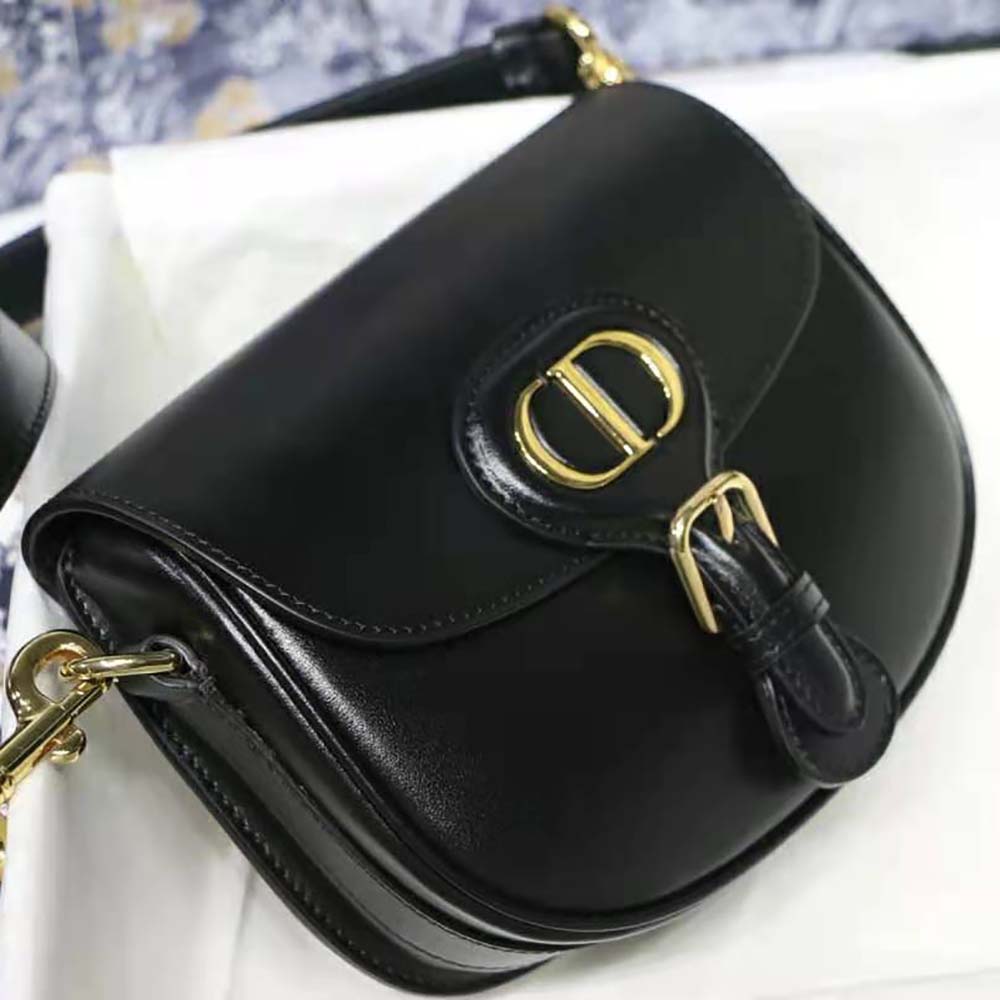 Side angle showing smooth black box calfskin texture on Dior Women Small Dior Bobby Bag
