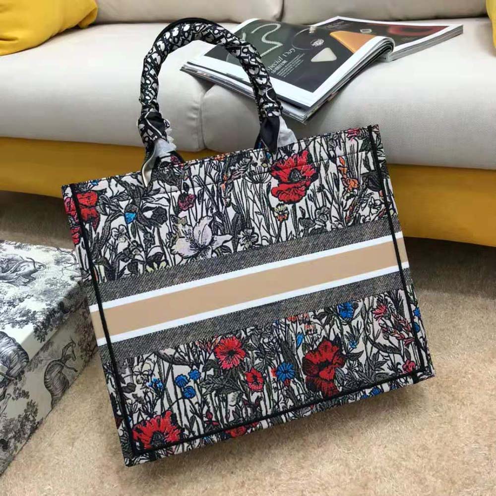 Side angle showing silver hardware and structured silhouette of Dior tote
