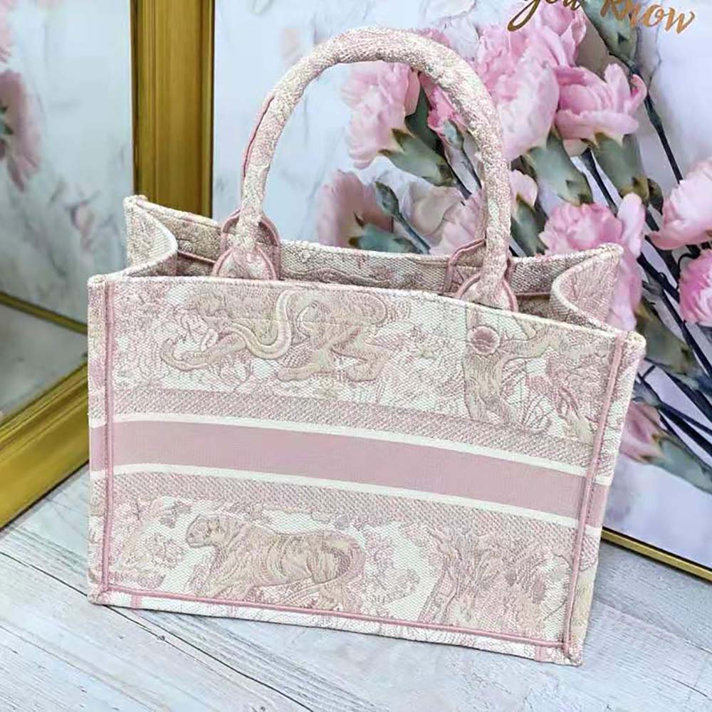 Side angle showing compact silhouette of Small Dior Book Tote pink handbag