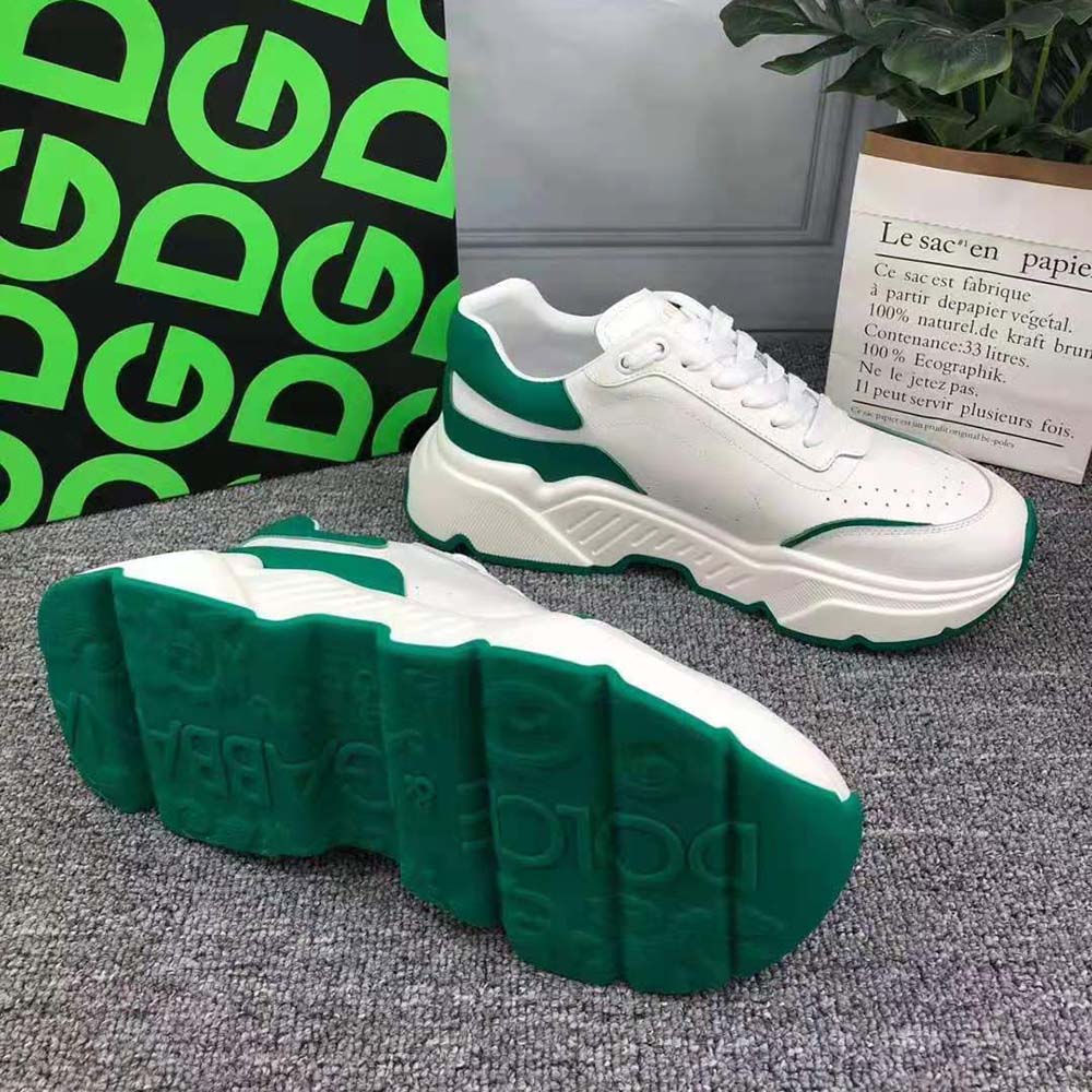 Close-up detail of embossed D&G logo on green leather sneaker