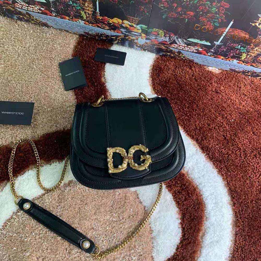 Close-up of gold-tone D&G logo hardware on bag flap