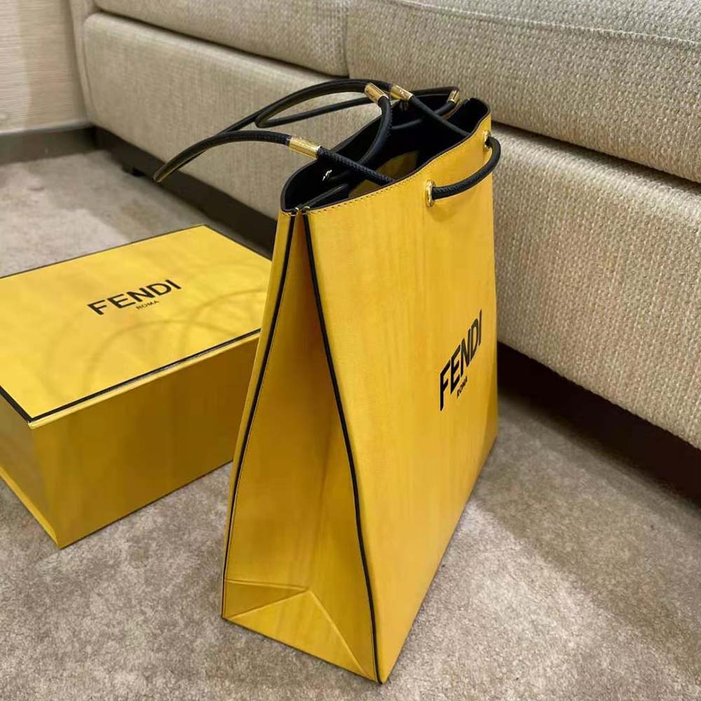 Side angle showing structured silhouette of Fendi Men Fendi Pack Medium Shopping Bag Yellow Leather Bag