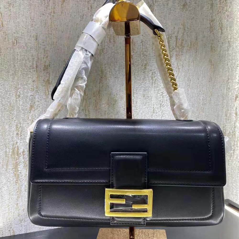 Close-up of gold-tone chain and black nappa leather on Fendi Women Baguette Chain Bag