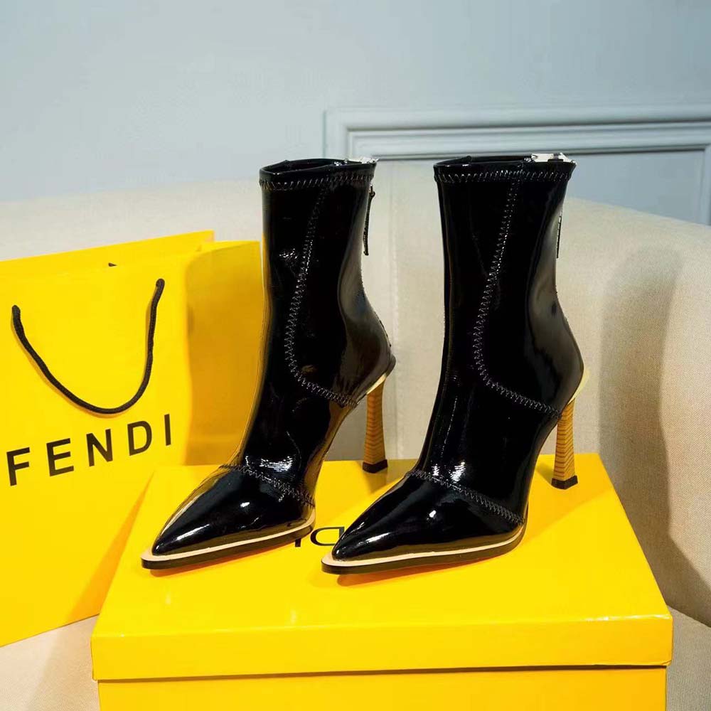 Close-up on glossy leather and Fendi hardware detail of biker boots