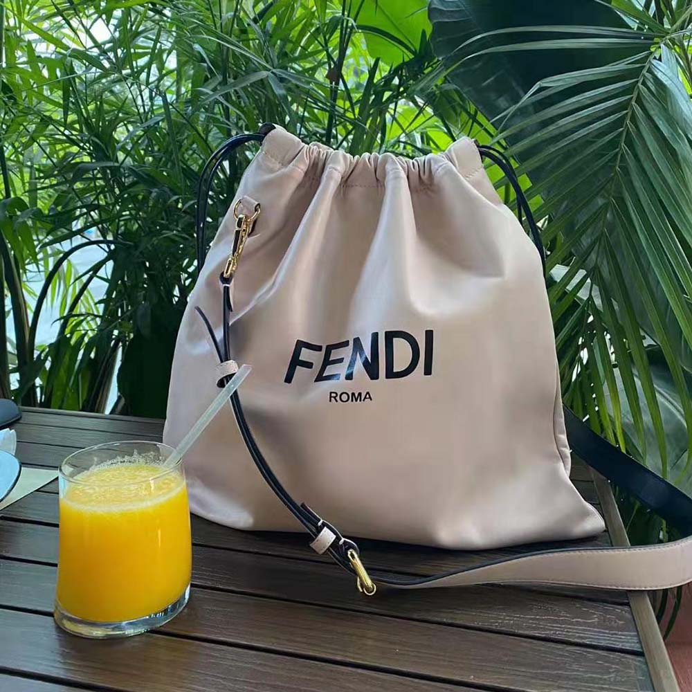 Close-up on gold-tone hardware detail of Fendi Pack Medium Pouch pink leather