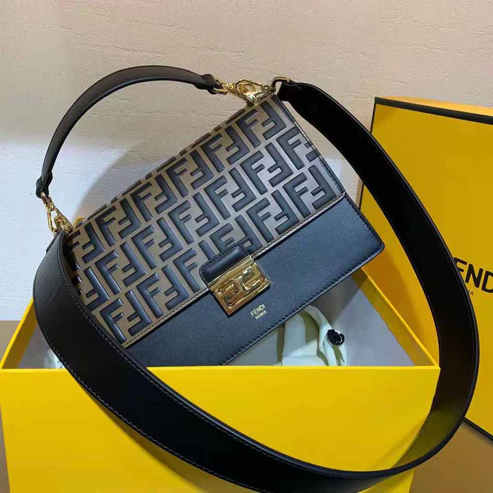 Close-up of gold-tone Fendi logo hardware on Kan U Black Leather Bag